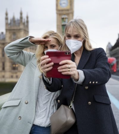 tourists visiting city wearing travel mask